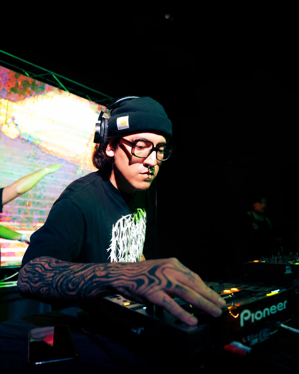 Gohtobi performing in front of a visual installation