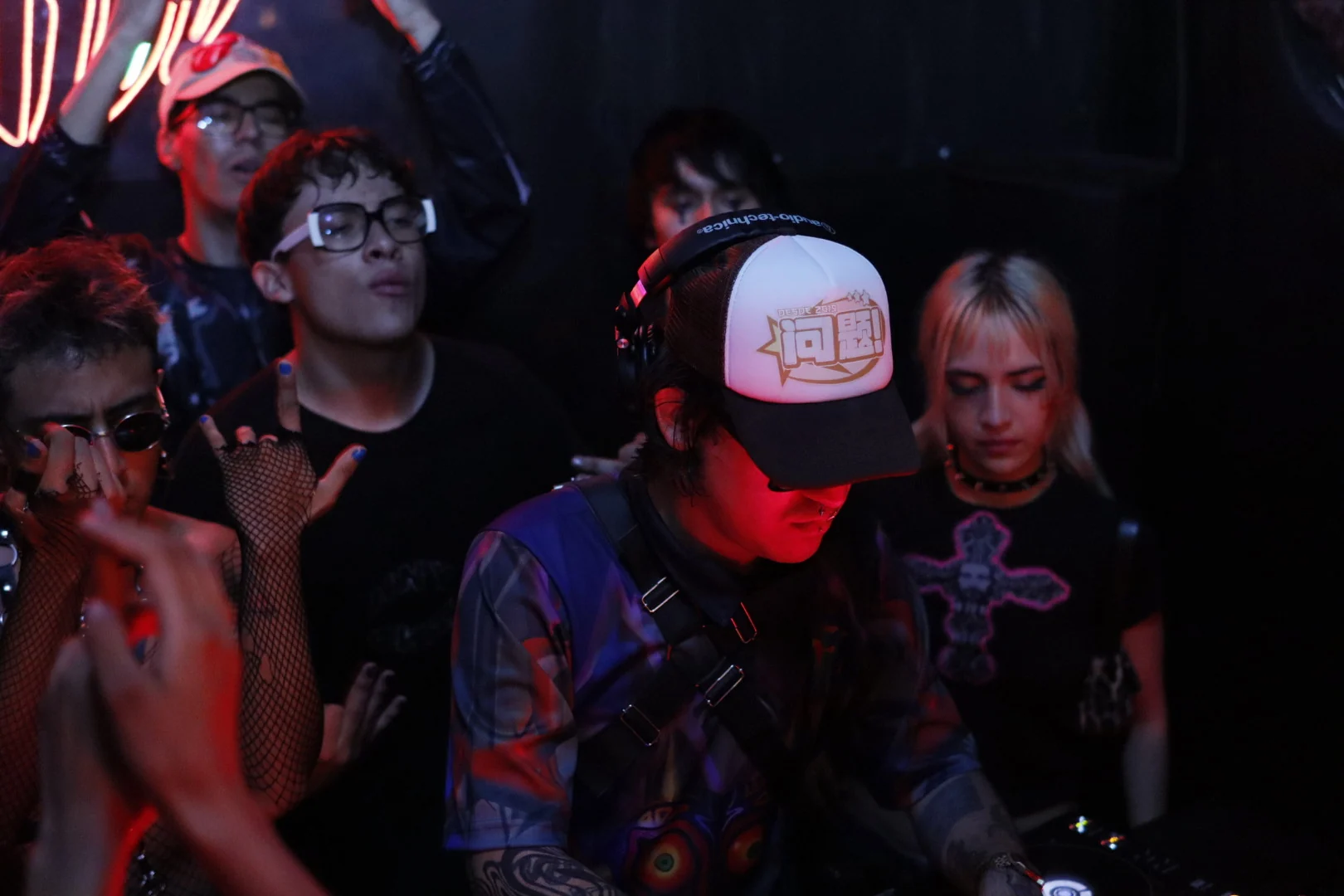 Gohtobi playing in a crowded club, people gathered around the booth
